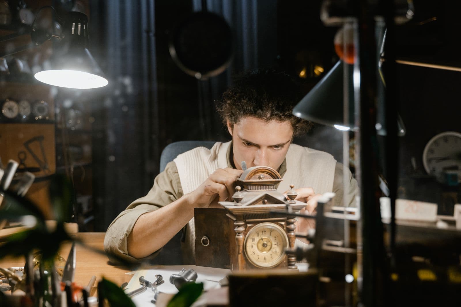 A watchmaker carefully restoring an antique clock